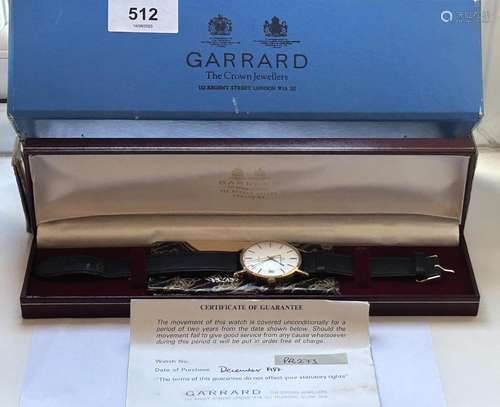 A 9CT GOLD GARRARD GENTS WRIST WATCH WITH LEATHER STRAP AND ...