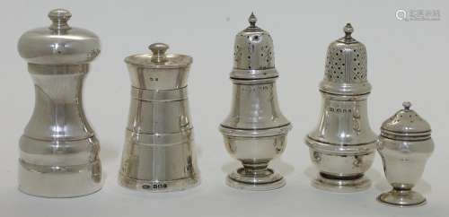 A small group of silver pepperettes and pepper mills, compri...