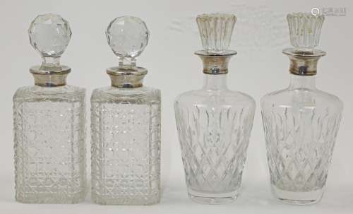 Four silver mounted cut glass decanters and stoppers, compri...