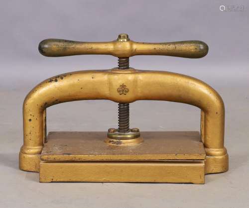 A Victorian cast iron book press, finished in brass, with ce...