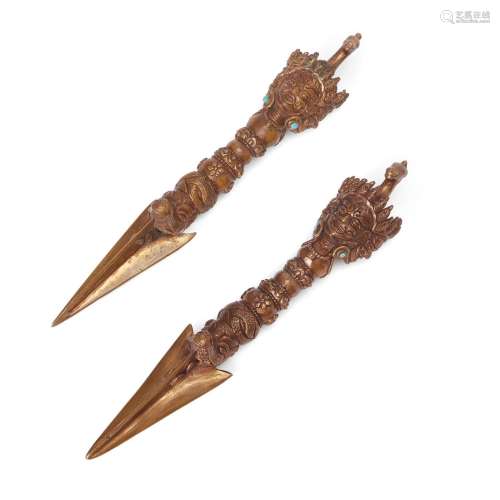 A pair of Tibetan gilt copper ritual pegs associated with th...