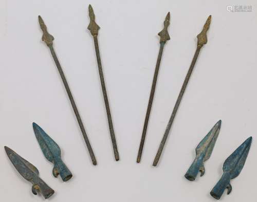 Four Chinese parcel gilt bronze arrows and four arrow heads,...