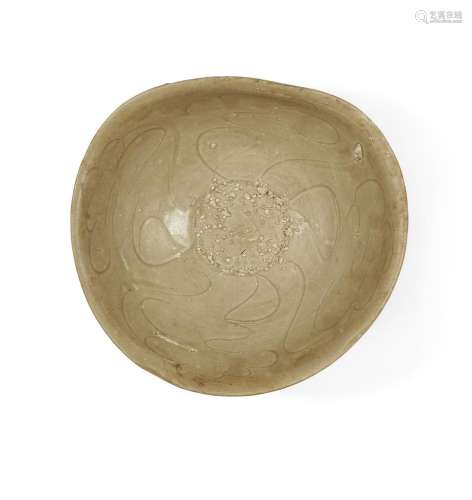 A Chinese incised celadon-glazed stoneware bowl, Ming dynast...