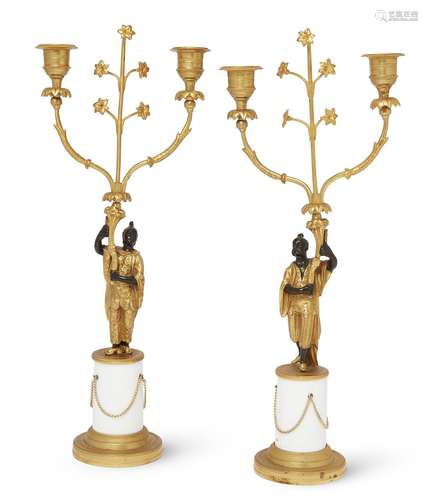 A pair of gilt and patinated bronze twin-light figural cande...