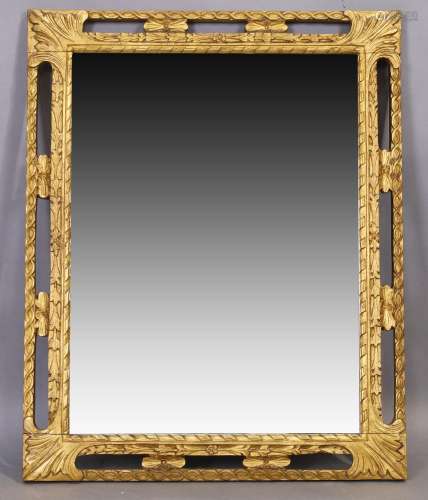 An English giltwood mirror with rectangular plate in pierced...