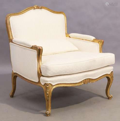 A French giltwood armchair, Louis XV style, 20th century, on...