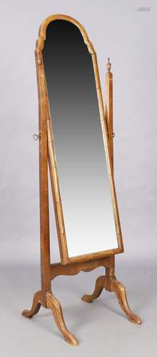 An English walnut cheval mirror, Queen Anne style, first qua...