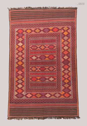 An Afghan Kilim, multicoloured geometric design, on a terrac...