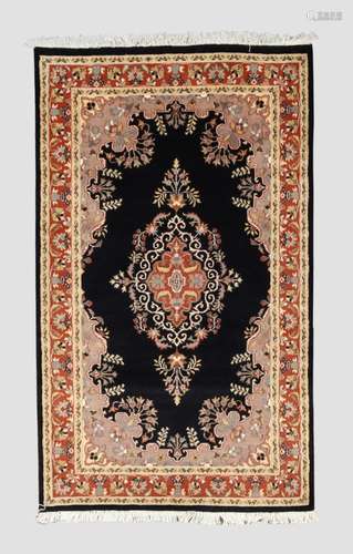 An Indian Kashmir rug, the central floral medallion, on a bl...