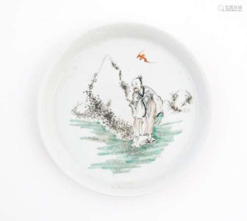 A Chinese plate / dish depicting a figure in lands…