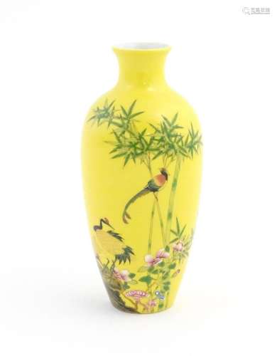 A Chinese vase with a yellow ground decorated with…