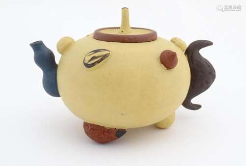 A Chinese Yixing teapot with nut and seed detail i…