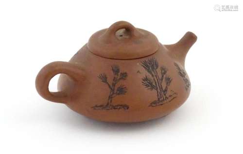 A Chinese Yixing teapot with incised tree and scri…
