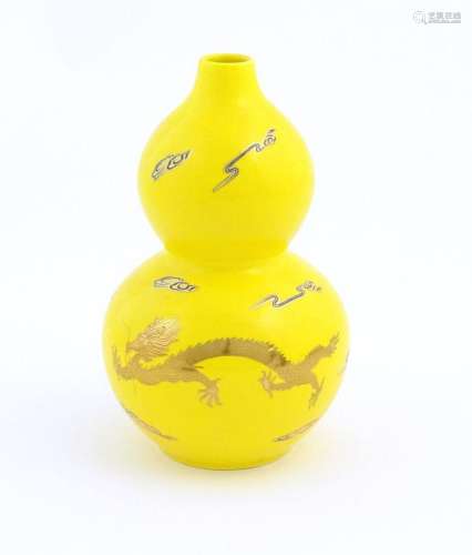 A Chinese double gourd vase with a yellow ground d…
