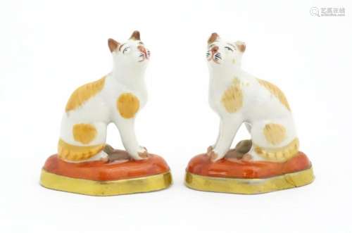 A pair of porcelain models of cats in the manner o…