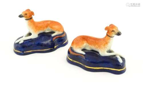A pair of Staffordshire pottery models of reclinin…