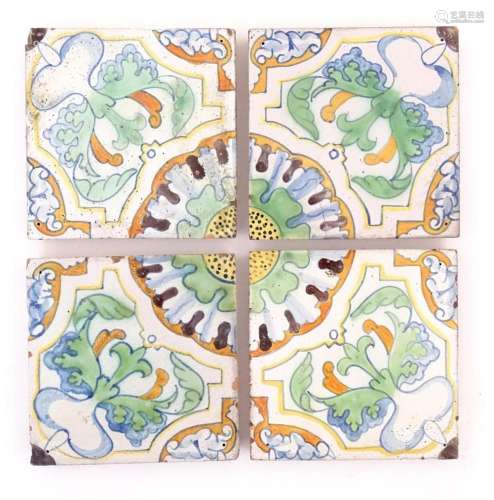 Four terracotta tiles with floral and foliate moti…