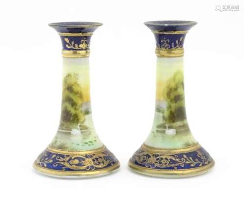 A pair of Noritake style candlesticks decorated wi…