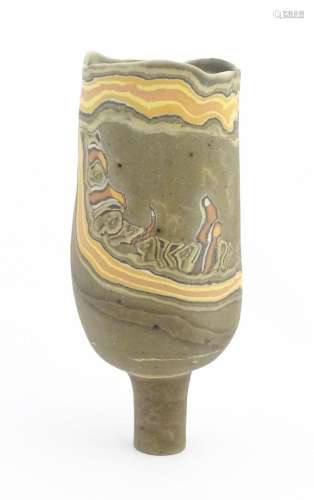 A studio pottery slender footed vase by Mal Magson…