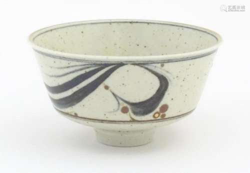 A studio pottery footed bowl with brushwork detail…