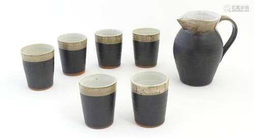 An Irish Shanagarry Pottery jug and six beakers by…