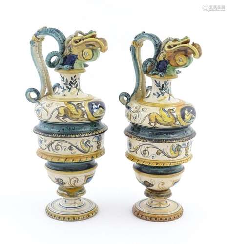 A pair of Italian maiolica wine ewers with fish he…