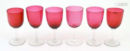 Six assorted cranberry glass drinking glasses, wit…