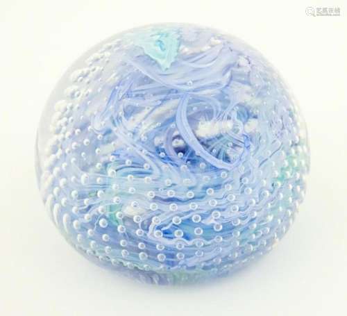 An art glass paperweight with swirled and bullican…