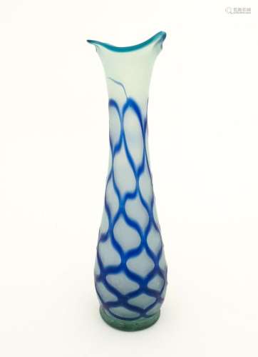 A tall art glass vase with blue and turquoise deta…