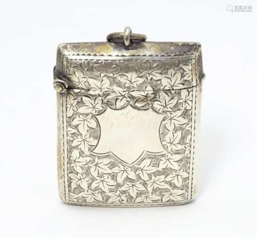 A silver vesta case with engraved foliate detail. …