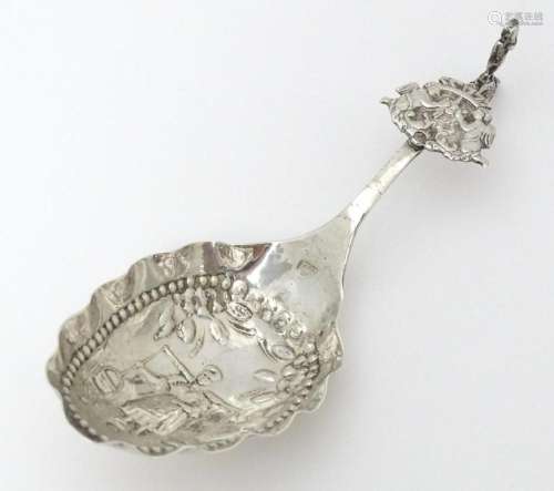 A Dutch silver caddy spoon with embossed decoratio…