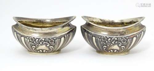 A pair of silver salts with embossed decoration. h…