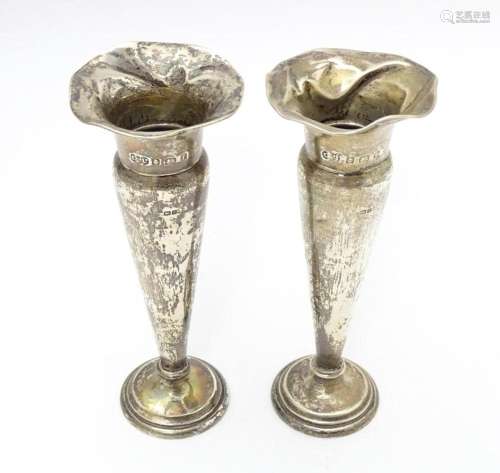 A pair of silver bud vases hallmarked Birmingham 1…