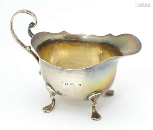 A silver cream jug hallmarked Birmingham 1901 make…
