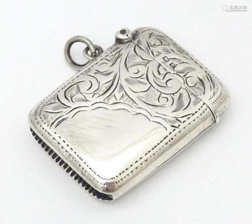 A silver vesta case with engraved decoration, hall…