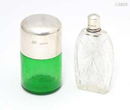 A green glass salts bottle with silver lid hallmar…