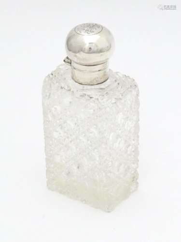 A cut glass scent / perfume bottle with silver mou…