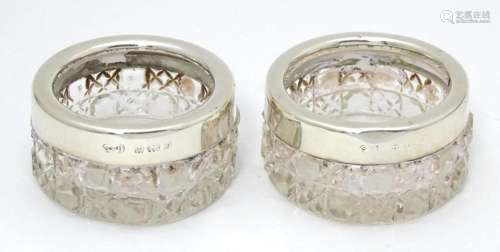 A pair of cut glass salts with silver rims, hallma…