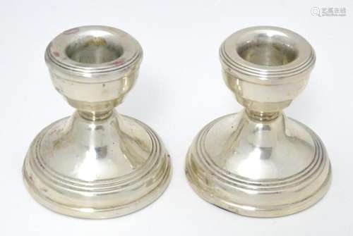 A pair of short silver candlesticks hallmarked Bir…