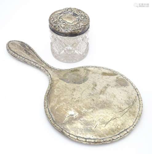 A silver hand mirror and together with a silver to…