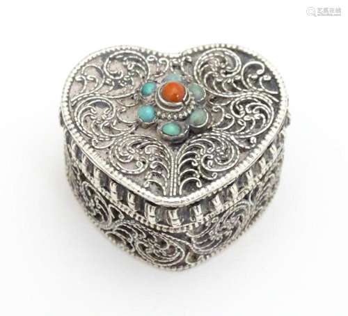 A pill box of heart form with turquoise and carnel…