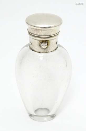 A glass scent / perfume bottle with white metal li…