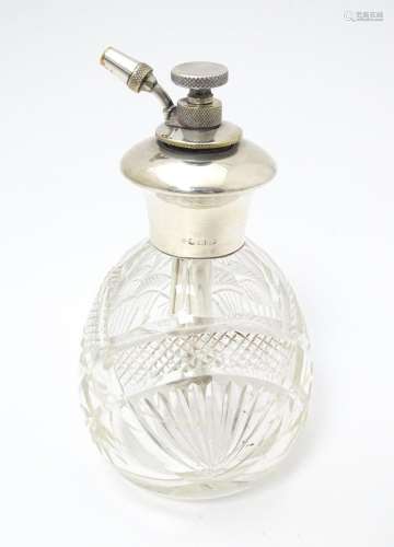 A cut glass perfume / scent bottle with silver ato…