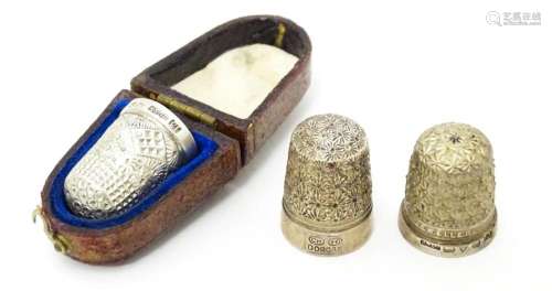 Three thimbles to include two silver examples, one…
