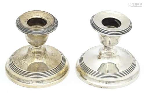 A pair of short silver candlesticks, hallmarked Bi…