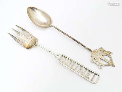 A white metal souvenir fork titled Brunei to handl…