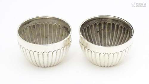 A pair of Victorian silver salts with fluted decor…