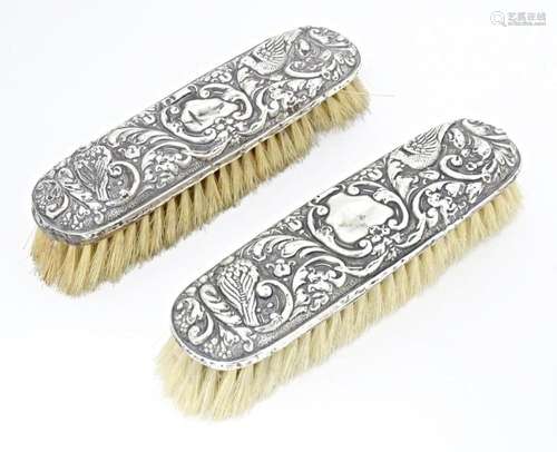 Two silver backed brushes with embossed decoration…