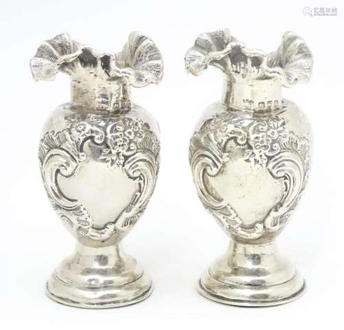 A pair of Victorian silver vases with flared rims,…