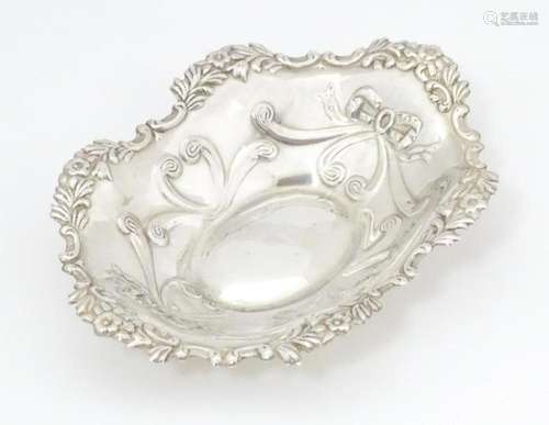 A silver bonbon dish of oval form with embossed de…